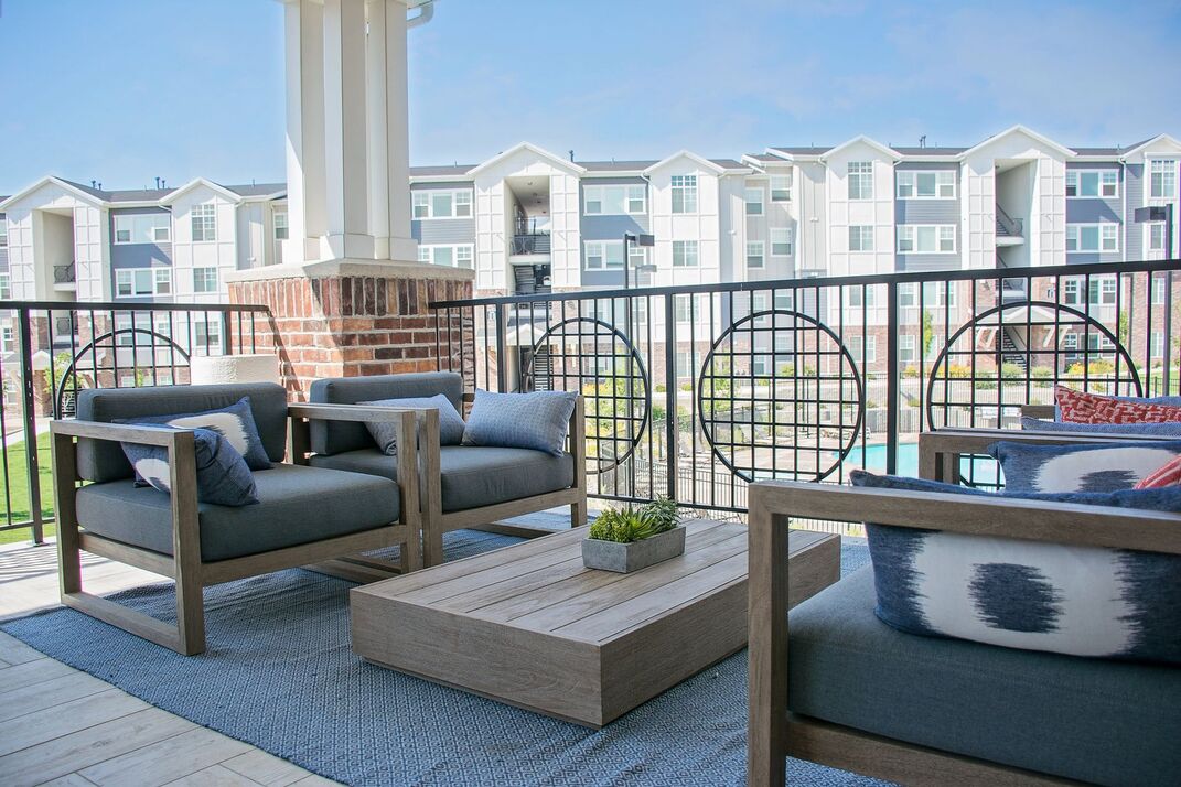 Balcony with arm chairs overlooking the pool